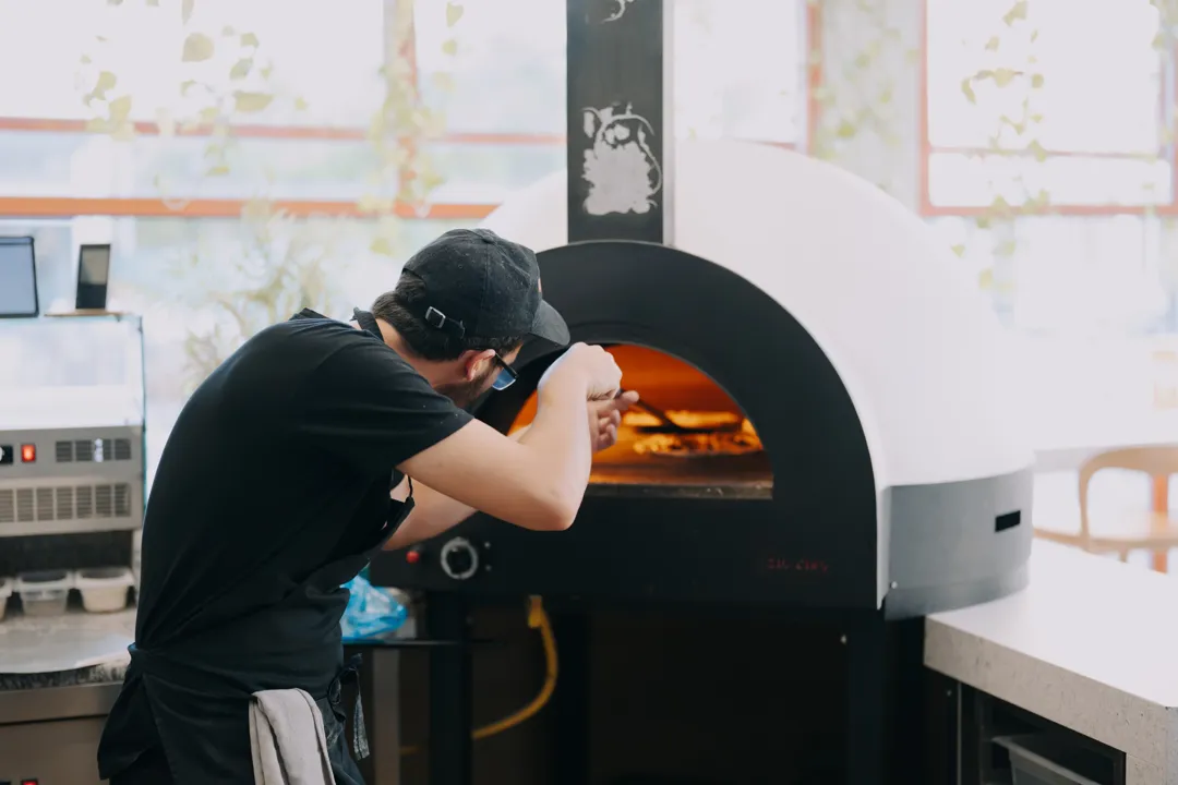 A pizzaiolo at Biga's wood-fired oven